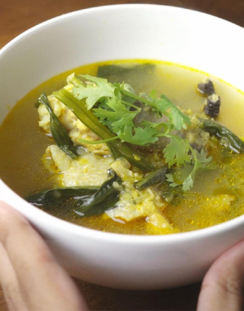 Kyat thout san hot and sour chicken soup in a white bowl
